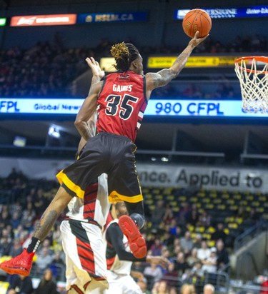 AJ Gaines Jr. of the London Lightning flies in on Windsor defender Sam Muldrow, who takes a foul, early in their NBL game Saturday night at Budweiser Gardens in London. Photograph taken on Saturday January 11, 2020. Mike Hensen/The London Free Press/Postmedia Network