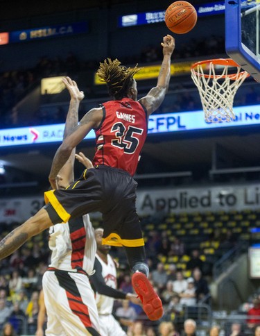 AJ Gaines Jr. of the London Lightning flies in on Windsor defender Sam Muldrow, who takes a foul, early in their NBL game Saturday night at Budweiser Gardens in London. Photograph taken on Saturday January 11, 2020. Mike Hensen/The London Free Press/Postmedia Network