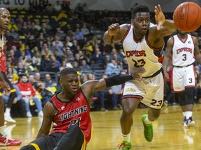 Abednego Lufile of the London Lightning loses the ball but draws the foul on Windsor's Kemy Osse in their NBL game Saturday, January 11 at Budweiser Gardens in London. 
(Mike Hensen/The London Free Press)