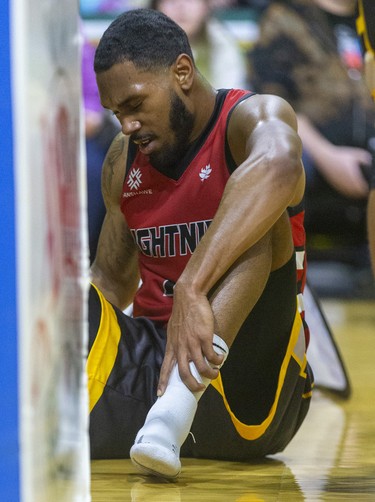 A frustrated Jaylon Tate of the London Lightning holds his ankle after a tough battle under the hoop against the Windsor Express in their NBL game Saturday night at Budweiser Gardens in London. Photograph taken on Saturday January 11, 2020. Mike Hensen/The London Free Press/Postmedia Network