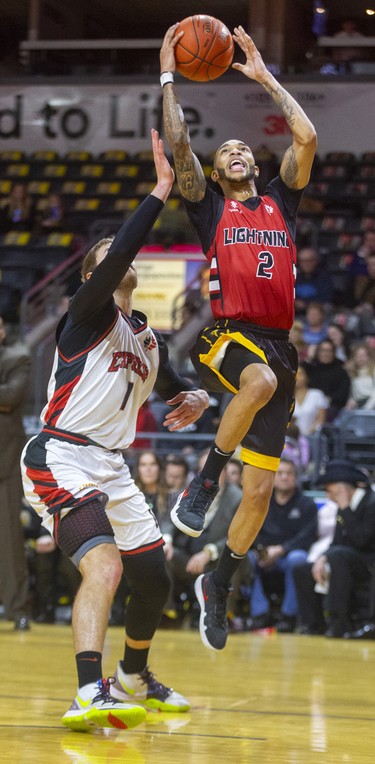 Xavier Moon of the London Lightning drives in around Jordan Bowling of the Windsor Express in their NBL game Saturday night at Budweiser Gardens in London. Photograph taken on Saturday January 11, 2020. Mike Hensen/The London Free Press/Postmedia Network