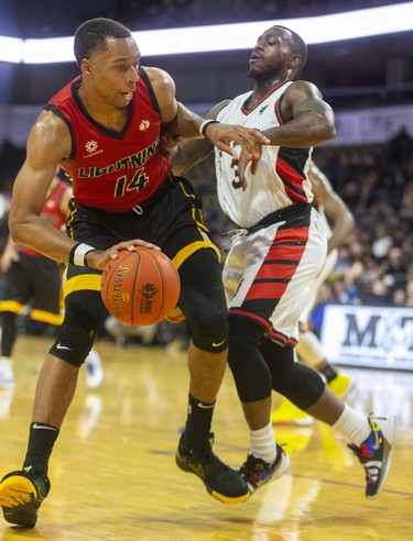 Mareik Isom of the London Lightning bounces off Chris Jones of the Windsor Express in their NBL game Saturday night at Budweiser Gardens in London. 
Photograph taken on Saturday January 11, 2020. Mike Hensen/The London Free Press/Postmedia Network