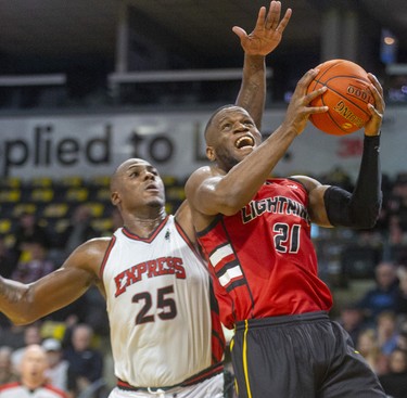 Abednego Lufile of the London Lightning drives in around Derrick Nix of the Windsor Express but couldn't get the bucket as the Lightning went cold in the second quarter of their game Saturday night at Budweiser Gardens in London. Photograph taken on Saturday January 11, 2020. Mike Hensen/The London Free Press/Postmedia Network