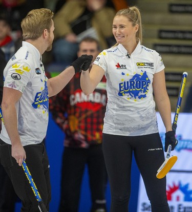 Sweden compatriots Niklas Edin and Sara McManus share a fist bump during their skins match Sunday afternoon against Canada's BJ Neufeld on the final day of the Continental Cup being played Sunday at the Western Fair Sports Centre in London, Ont. 
Photograph taken on Sunday January 12, 2020. 
Mike Hensen/The London Free Press/Postmedia Network