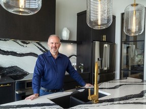 London Home Builders' Association president Toby Stolee of Sifton Homes shows off a quartz countertop with a dramatic pattern which will be on display at Cambria quartz's booth at next weekend's Lifestyle Home Show in London. (MIKE HENSEN, The London Free Press)
