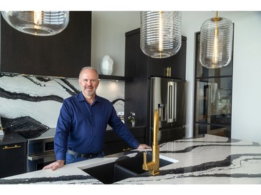 London Home Builders' Association president Toby Stolee of Sifton Homes shows off a quartz countertop with a dramatic pattern which will be on display at Cambria quartz's booth at next weekend's Lifestyle Home Show in London. (MIKE HENSEN, The London Free Press)