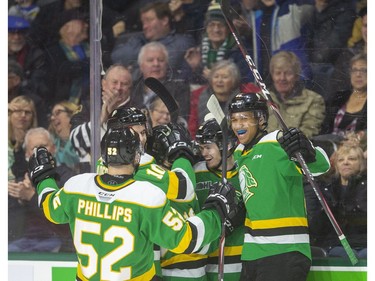 Number 34 for Connor McMichael as he's congratulated by Markus Phillips, Stuart Rolofs, Sean McGurn and Bryce Montgomery Brett Brochu of the Knights juggles a puck that ended up in his crease but was swept away by Markus Phillips as the Knights hosted the Hamilton Bulldogs at Budweiser Gardens on Friday January 24, 2020.  (Mike Hensen/The London Free Press)