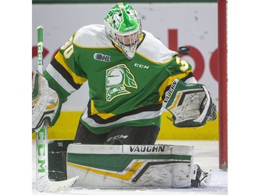 Brett Brochu of the Knights juggles a puck that ended up in his crease behind him, but was saved by Markus Phillips as the London Knights host the Hamilton Bulldogs at Budweiser Gardens on Friday Jan. 24, 2020.   (Mike Hensen/The London Free Press)