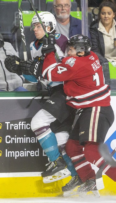 The Guelph Storm were told to get physical and tried to use the body to slow the London Knights down. Here, Cedric Ralph pins Luke Evangelista up against the boards in the first period of their Sunday afternoon at Budweiser Gardens in London. Photograph taken on Sunday January 26, 2020. 
Mike Hensen/The London Free Press/Postmedia Network