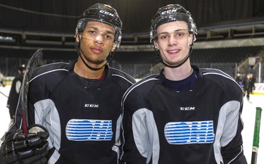 Knights defensemen Bryce Montgomery and Benjamin Roger pause during practice at Budweiser Gardens in London. (Mike Hensen/The London Free Press)