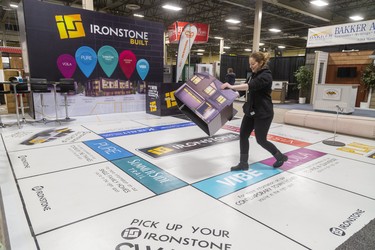 Leia Smoudianis of The Ironstone Building Company moves a house onto SummerSide Trail as they set up a huge monopoly board for the Lifestyle Home show this weekend at the Western Fair's Agriplex in London, Ont.  Photograph taken on Thursday January 30, 2020.  Mike Hensen/The London Free Press/Postmedia Network