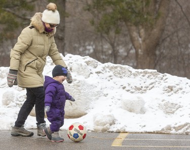 The last day of January is a perfect time for some soccer in the Storybook Gardens parking lot, as Mariane Hossfeld plays with her granddaughter Lucia Salazar-Hossfeld, 2.  (Mike Hensen/The London Free Press)