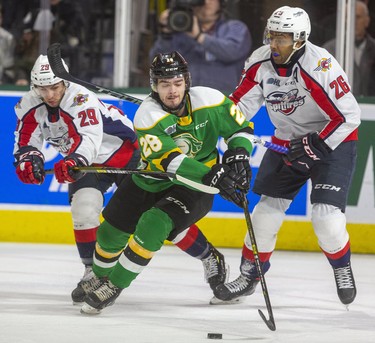 Ryan Merkley of the Knights attracts a crowd as he attempts to stick handle out of his zone with Daniel D'Amico and Cole Purboo on the chase during their game at Budweiser Gardens in London, Ont.  on Friday January 31, 2020.  The Spits took a 2-0 lead in the first. Mike Hensen/The London Free Press/Postmedia Network