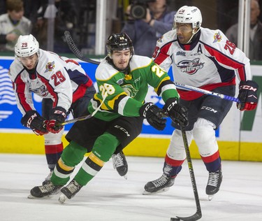 Ryan Merkley of the Knights attracts a crowd as he attempts to stickhandle out of his zone with Daniel D'Amico and Cole Purboo on the chase during their game at Budweiser Gardens in London, Ont.  on Friday January 31, 2020.  The Spits took a 2-0 lead in the first. Mike Hensen/The London Free Press/Postmedia Network