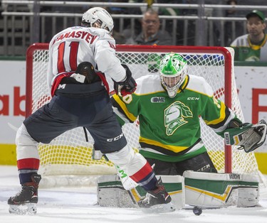 Egor Afanasyev of the Spitfires tries to get to a rebound in front of Knights goaltender Brett Brochu during their game at Budweiser Gardens in London, Ont.  on Friday January 31, 2020.  The Spits took a 2-0 lead in the first. Mike Hensen/The London Free Press/Postmedia Network