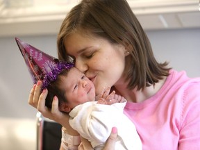 Mom Ania Dolganiuk holds her newborn girl, Maya, who was the first baby born in Calgary in 2020. (Darren Makowichuk/Postmedia Network)