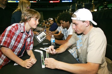 David Mendham, 7, watches as London Knights leading scorer Patrick Kane signs his stick during the London Knights open house in February 2007. (Sue Reeve/The London Free Press)
