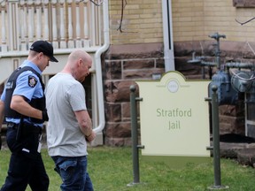 Harley Schneider is led towards the jail by a Stratford police special constable on Wednesday January 15, 2020 in Stratford, Ont. (Terry Bridge/Stratford Beacon Herald)
