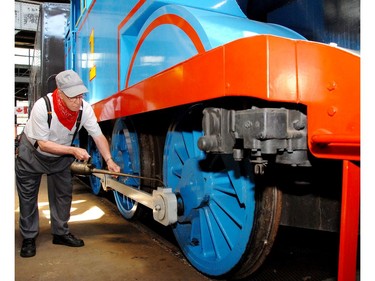 Ron Bareham tops up the oil in the journal box of Thomas The Tank Engine as it rests at the museum prior to its first weekend of Day Out With Thomas at the St. Thomas-Elgin Memorial Centre. (Postmedia Network file photo)