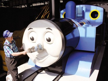 Ron Bareham gives Thomas The Tank Engine a little dusting after its long journey to St. Thomas in preparation for the annual Day Out With Thomas at St. Thomas Elgin Memorial Centre. (Postmedia Network file photo)