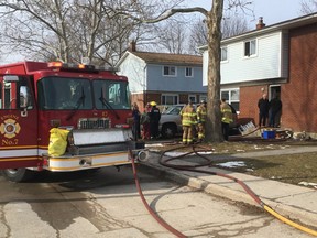 Two London firefighters suffered “minor” injuries, officials say, after being called to a Thursday morning townhouse blaze at 312 Boullee St. in northeast London. (Derek Ruttan/The London Free Press)