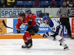 Owen Sound Attack forward Matthew Struthers (15) races after a puck while Sudbury Wolves defenceman Peter Stratis (24) gives chase during OHL action at Sudbury Community Arena in Sudbury, Ontario on Saturday, December 14, 2019. (Ben Leeson/Postmedia Network)