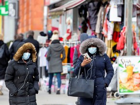 Pedestrians walk in the Chinatown district of downtown Toronto, Ontario, after patients with novel coronavirus were reported in Canada. (Carlos Osorio/Reuters)