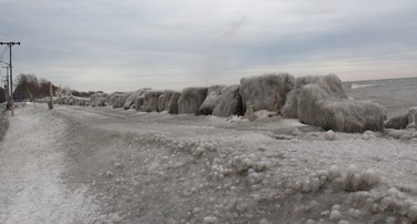 Big waves from Lake Erie, powered by strong winds, combined with freezing temperatures has left a thick coating of ice along the walkway into Erieau on Saturday February 15, 2020. Ellwood Shreve/Chatham Daily News/Postmedia Network