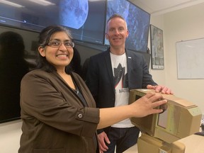 Western Professor Jayshri Sabarinathan and Western Space Director Gordon Osinski show off a prototype of a camera that will one day be a part of international missions to the moon. (HEATHER RIVERS, The London Free Press)