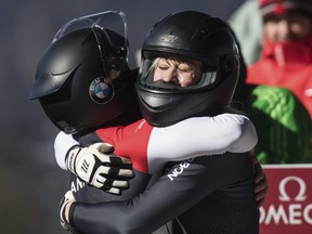 Canada's Kristen Bujnowski, right, and Christine de Bruin embrace after racing to a third-place finish during the women's bobsled event at the Bobsleigh World Championships in Whistler, British Columbia, Sunday March 3, 2019. (Darryl Dyck/The Canadian Press via AP)