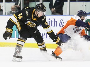 Sarnia Sting's Eric Hjorth (55) slows Flint Firebirds' Brennan Othmann (78) in the second period at Progressive Auto Sales Arena in Sarnia, Ont., on Wednesday, Feb. 26, 2020. (Mark Malone/Chatham Daily News/Postmedia Network)