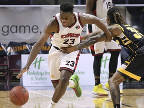 Kemy Osse, left, of the Windsor Express drives pass AJ Gaines of the London Lightning during their game on Wednesday, February 26, 2020 at the WFCU Centre in Windsor, ON. (DAN JANISSE/The Windsor Star)