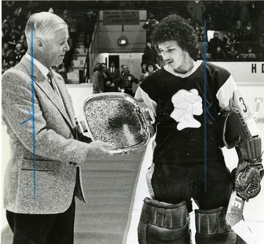 London Knights' general manager Bill Long presents a silver tray to his goalie Frank Caprice, to recognize his contribution to Canada's world championship junior team, 1982. (London Free Press files)