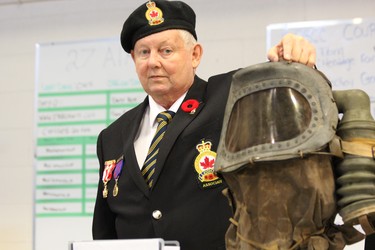 Graham Smith of the Royal Canadian Legion showcases a baby gas mask, a British-made device intended to protect children from gas warfare during the Second World War. The gas mask was just one of many pieces of memorabilia on display at the HMCS Prevost Saturday during the annual Heritage Fair. DALE CARRUTHERS / THE LONDON FREE PRESS