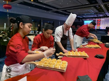 Fanshawe College culinary arts students Julie Dela Cruz, left and Irish De Guzman, chef and instructor Alex Mollet and graduate Kenny Tan prepare tangerine steamed cake appetizers at the Dragon Gala reception Saturday Feb. 8, 2020. The annual event at RBC Place celebrates the Chinese New Year. (Jennifer Bieman/The London Free Press)
