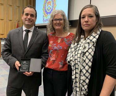 Det.-Const. Chris Adamovich received an award from the London Abused Women’s Centre on Thursday at the monthly police board meeting. The agency’s executive director, Megan Walker, centre, and staffer Jennifer Dunn, right, presented Adamovich with the citation. Dale Carruthers / The London Free Press