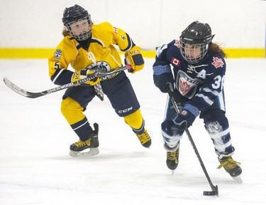 Makenna Ferguson of the Brampton Canadettes skates away from Abigail Smith of the Whitby Wolves at the 30th Annual London Devilettes Tournament in London on Sunday. (Derek Ruttan/The London Free Press)