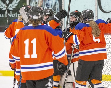 The London Devilettes swarm goaltender Kylie Hall after their 3-1 win over the Norfolk Hericanes during the Mid/Int HL championship game at the 30th Annual London Devilettes Tournament in London on Sunday. (Derek Ruttan/The London Free Press)