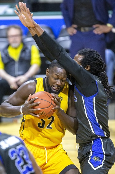 Randy Phillips of the London Lightning collides with Nigel Tygther (cct) of the Kitchener-Waterloo Titans while driving to the net in London, Ont. on Friday February 7, 2020. Derek Ruttan/The London Free Press/Postmedia Network
