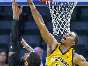 Mareik Isom of the London Lightning prevents a basket by Justin Moss of the Kitchener-Waterloo Titans during their National Basketball League of Canada game at Budweiser Gardens in London on Thursday. (Derek Ruttan/The London Free Press)