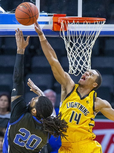 Mareik Isom of the London Lightning prevents a basket by Justin Moss of the Kitchener-Waterloo Titans in London, Ont. on Friday February 7, 2020. Derek Ruttan/The London Free Press/Postmedia Network