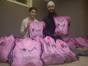 Prabhjjot Kaur (left) and Ajeet Singh were two of many volunteers bagging goods to be donated to four women's groups in London. Every year, the World Sikh Organization of Canada and Sikhs across Canada, in partnership with local community organizations, mark February 14th by delivering baked goods, Valentines cards, chocolates and personal care items to womenÕs shelters as part of the One Billion Rising movement. (Derek Ruttan/The London Free Press)