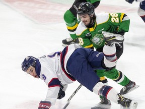 Dalton Duhart of the Saginaw Spirit trips while being harassed by Ryan Merkley of the London Knights in London. (Derek Ruttan/The London Free Press)