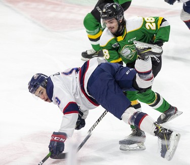 Dalton Duhart of the Saginaw Spirit trips while being harassed by Ryan Merkley of the London Knights in London. (Derek Ruttan/The London Free Press)