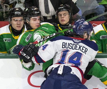 DJ Busdeker of the Saginaw Spirit squishes Luke Evangelista of the London Knights in London. Derek Ruttan/The London Free Press/Postmedia Network