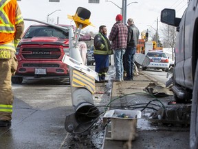 No one was injured but noon hour traffic was snarled at London's busiest intersection, Commissioners Road at Wellington Road, after a vehicle struck a centre median light pole. The pole then fell on top of a vehicle that was stopped in left hand turn lane. Photo shot in London, Ont. on Friday February 14, 2020. Derek Ruttan/The London Free Press/Postmedia Network