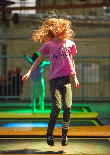 Eight-year-old Penny Smith (and her hair) enjoy an afternoon of trampolining at The Factory in London, Ont. on Monday February 17, 2020. The trampolines feature different coloured lights underneath the canvas. She was visiting The Factory from her home in Tillsonburg with here parents Rebecca and Jeff.Derek Ruttan/The London Free Press/Postmedia Network