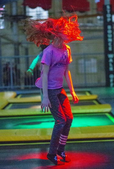 Eight-year-old Penny Smith (and her hair) enjoy an afternoon of trampolining at The Factory in London, Ont. on Monday February 17, 2020. The trampolines feature different coloured lights underneath the canvas. She was visiting The Factory from her home in Tillsonburg with here parents Rebecca and Jeff.Derek Ruttan/The London Free Press/Postmedia Network