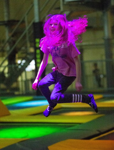 Eight-year-old Penny Smith (and her hair) enjoy an afternoon of trampolining at The Factory in London, Ont. on Monday February 17, 2020. The trampolines feature different coloured lights underneath the canvas. She was visiting The Factory from her home in Tillsonburg with here parents Rebecca and Jeff.Derek Ruttan/The London Free Press/Postmedia Network