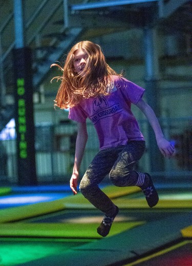 Eight-year-old Penny Smith (and her hair) enjoy an afternoon of trampolining at The Factory in London, Ont. on Monday February 17, 2020. The trampolines feature different coloured lights underneath the canvas. She was visiting The Factory from her home in Tillsonburg with here parents Rebecca and Jeff.Derek Ruttan/The London Free Press/Postmedia Network